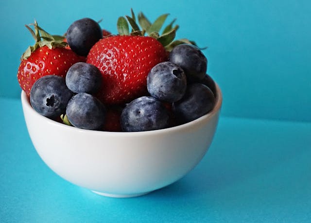 top down view of a bunch of different berries such as blackberries, blueberries, raspberries, and strawberries