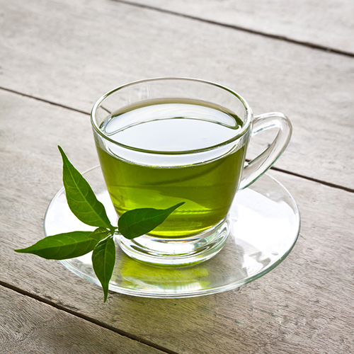 glass mug of green tea outside 