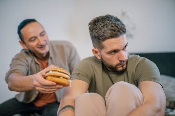 man refusing a burger