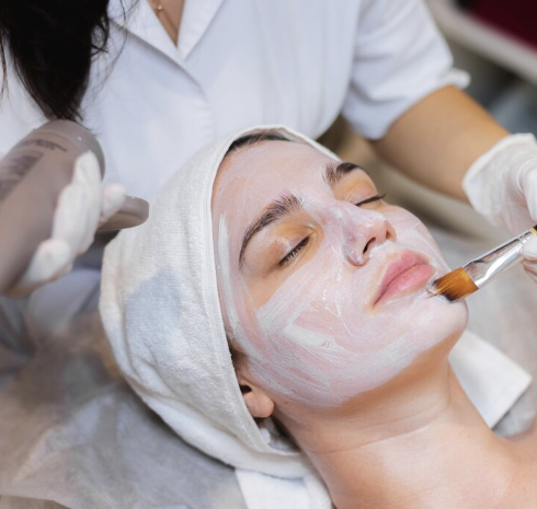 woman applying a face mask to another womans face