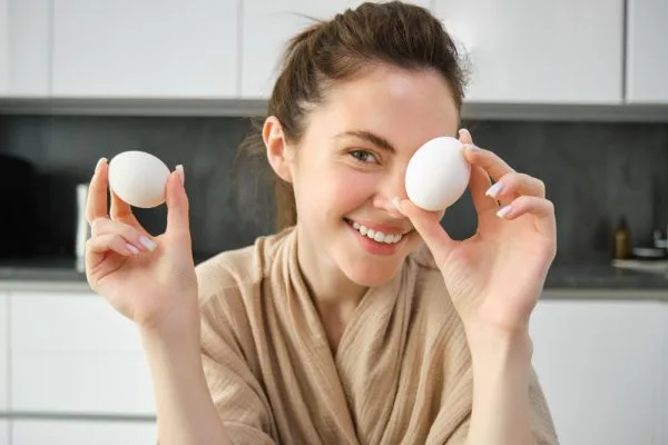 Woman holding 2 eggs